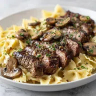 Garlic Butter Steak with Creamy Bowtie Pasta and Mushrooms
