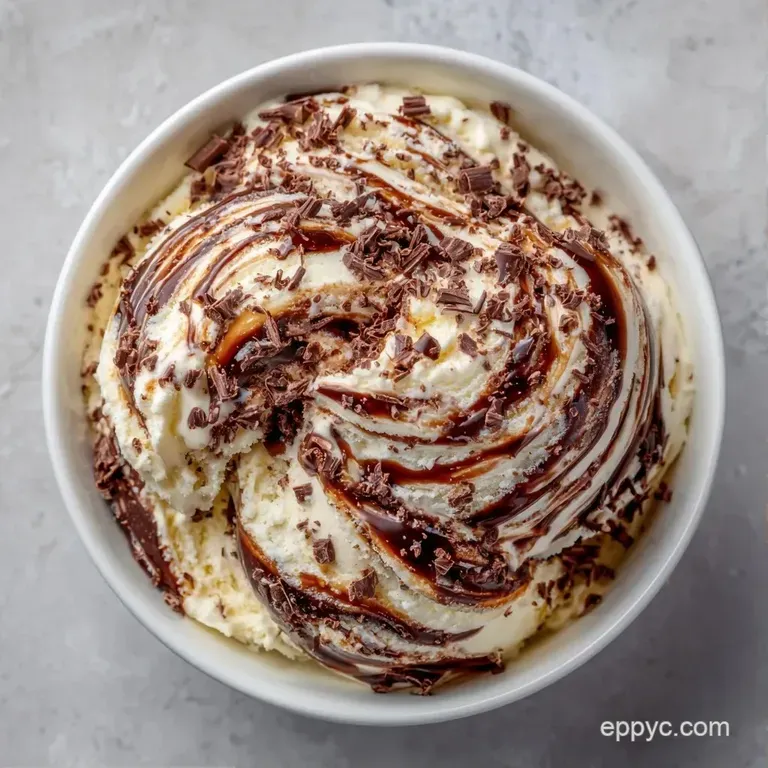 Elegantly served white gelato in a crystal glass, swirled with hot dark coffee and a sprig of mint on top.