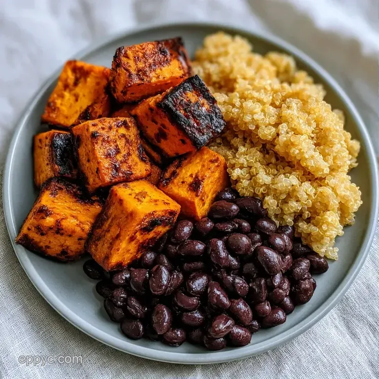 A vibrant mix of dark beans and fluffy grains topped with creamy avocado slices and a zesty fresh lime wedge.